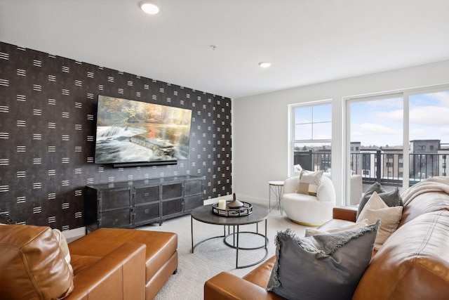 living room featuring an accent wall, recessed lighting, carpet floors, wallpapered walls, and baseboards