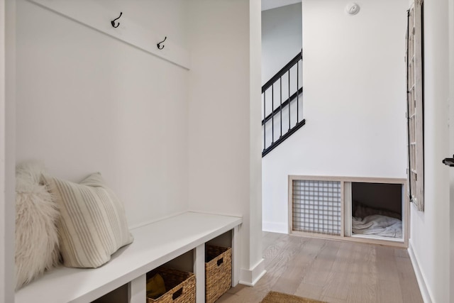 mudroom with baseboards and wood finished floors