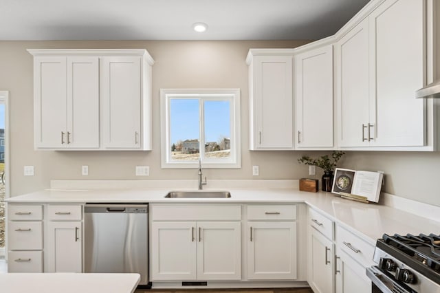 kitchen featuring sink, white cabinets, stainless steel dishwasher, and range with gas cooktop