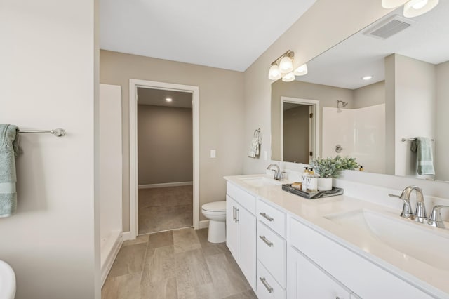 bathroom featuring a shower, hardwood / wood-style flooring, toilet, and vanity