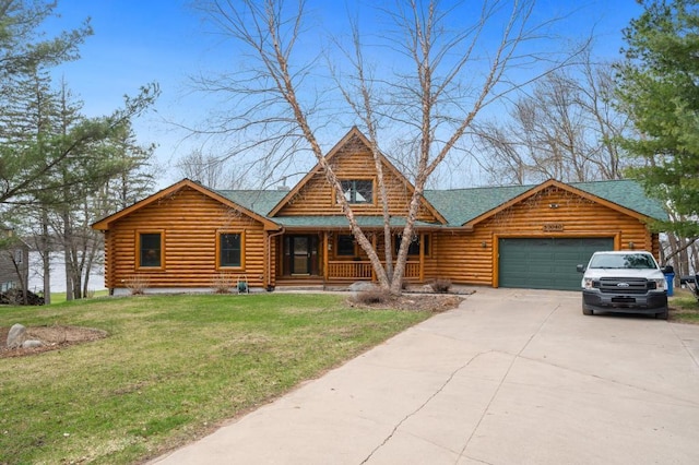 cabin featuring a garage, a front lawn, and a porch