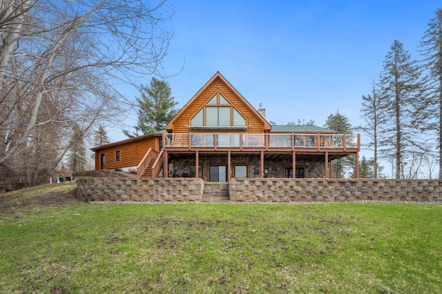 rear view of property featuring a deck and a lawn