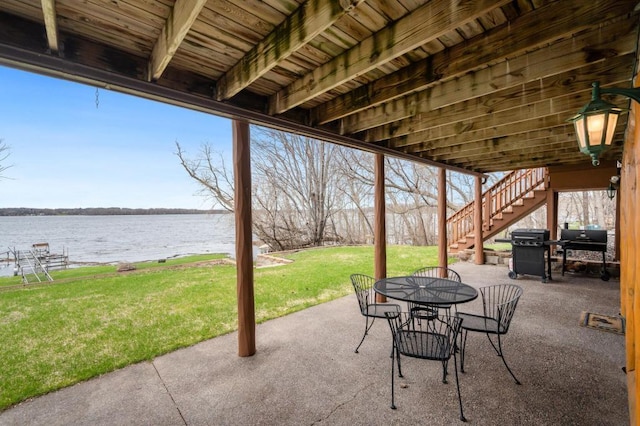 view of patio with a water view and area for grilling