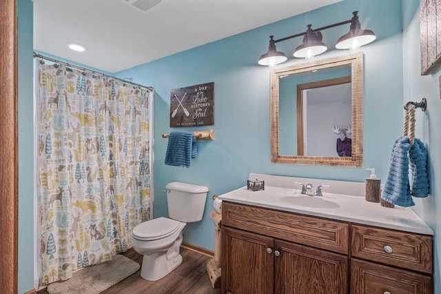 bathroom featuring toilet, vanity, a shower with shower curtain, and hardwood / wood-style floors