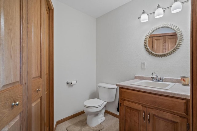 bathroom featuring toilet and vanity