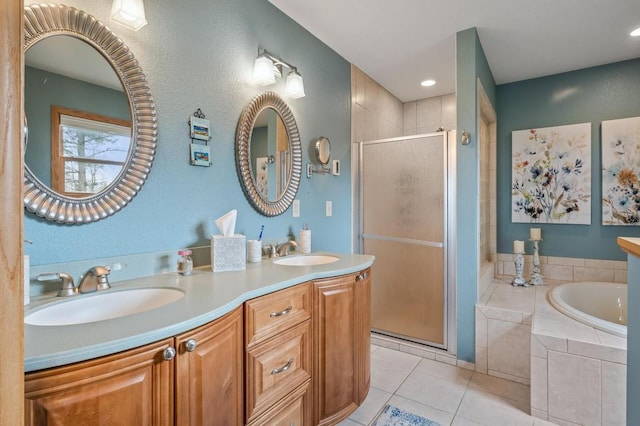 bathroom with vanity, tile patterned floors, and shower with separate bathtub