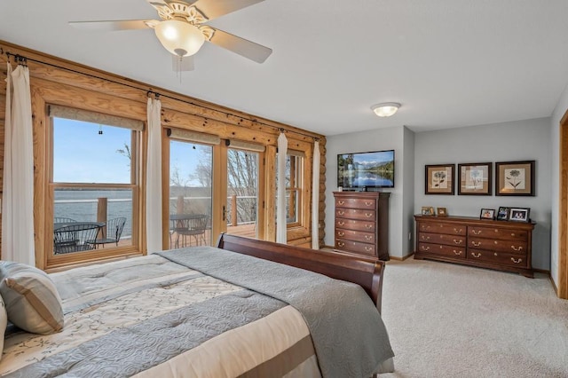 carpeted bedroom with ceiling fan and a water view