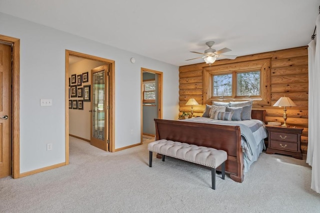 carpeted bedroom featuring ceiling fan and rustic walls