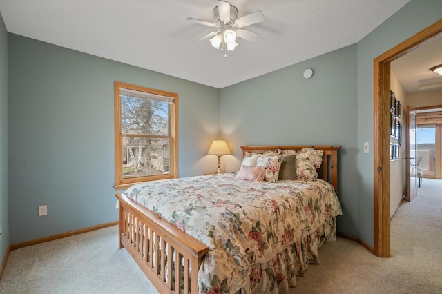 bedroom with ceiling fan, light colored carpet, and multiple windows