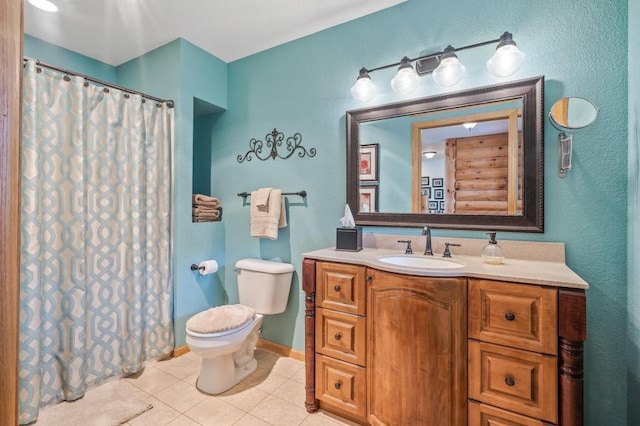 bathroom with toilet, vanity, and tile patterned flooring