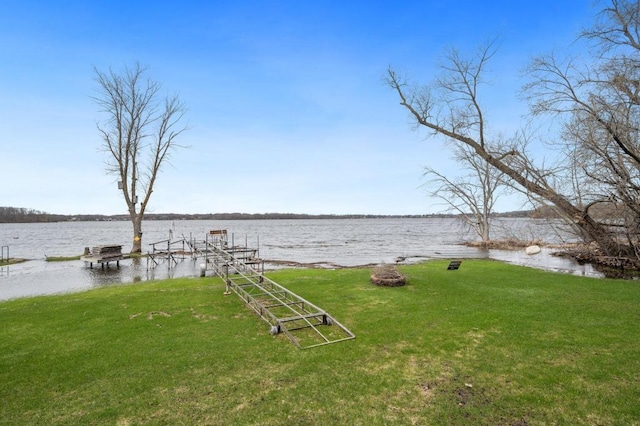 dock area featuring a water view and a lawn