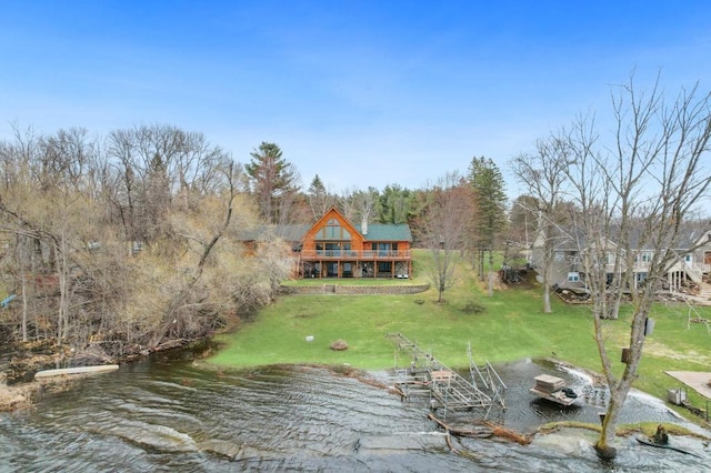 exterior space featuring a yard and a water view