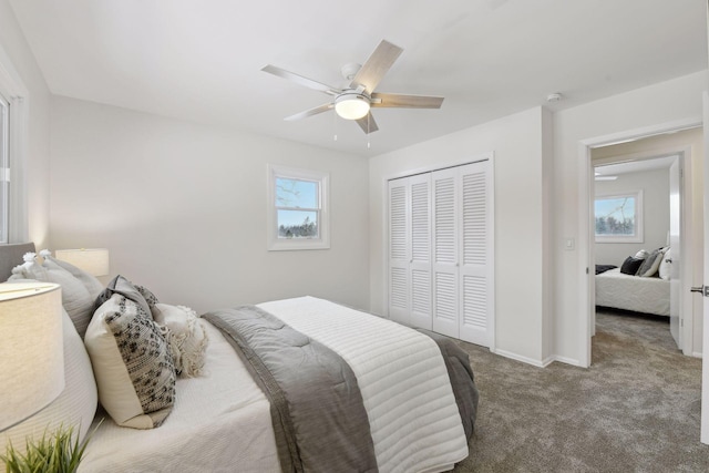 carpeted bedroom featuring ceiling fan and a closet