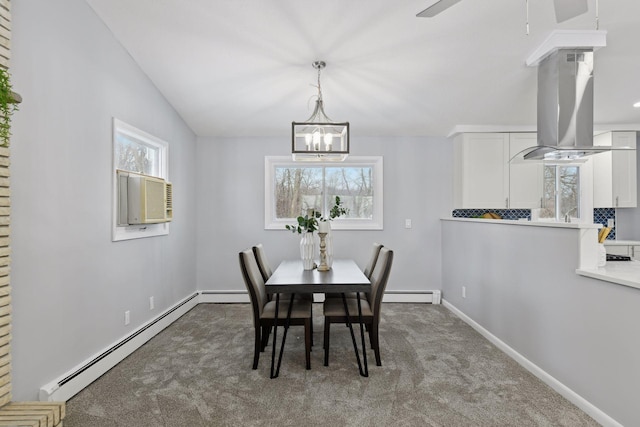 dining space featuring carpet floors, baseboard heating, and vaulted ceiling