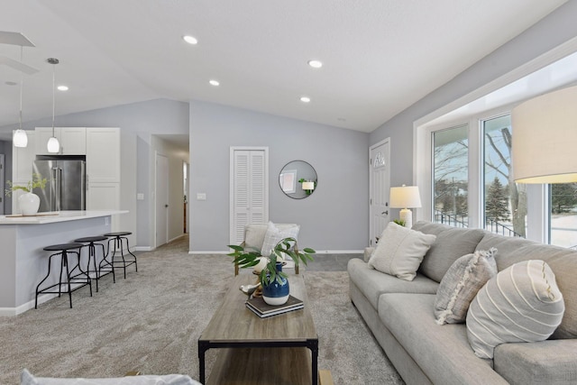 carpeted living room featuring lofted ceiling