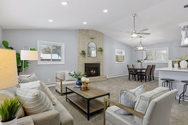 living room featuring ceiling fan, vaulted ceiling, a brick fireplace, and a baseboard radiator