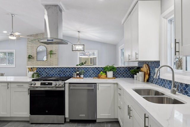 kitchen featuring white cabinetry, island range hood, stainless steel appliances, lofted ceiling, and sink