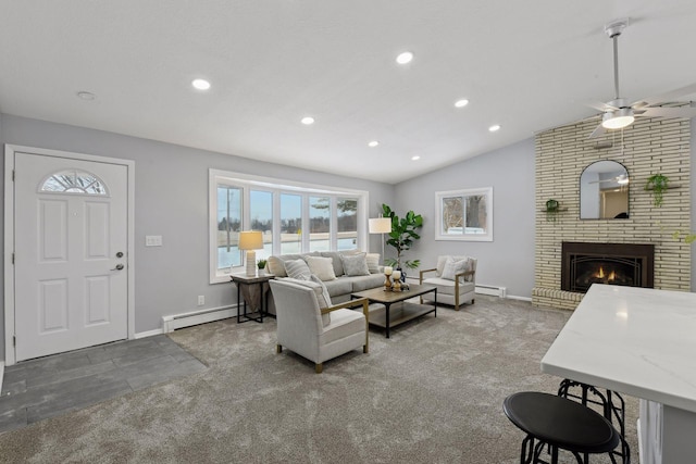 carpeted living room with ceiling fan, lofted ceiling, a fireplace, and a baseboard radiator