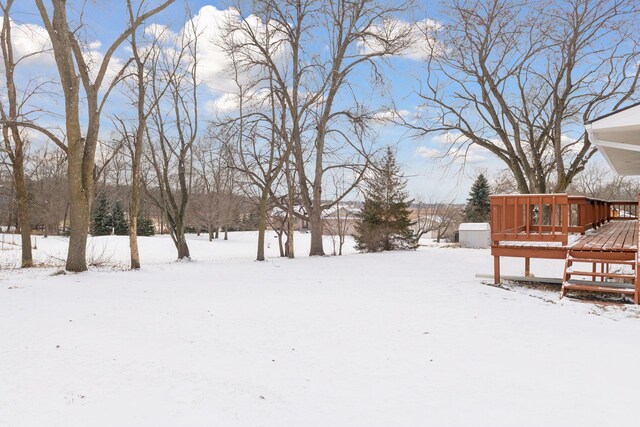 snowy yard with a wooden deck