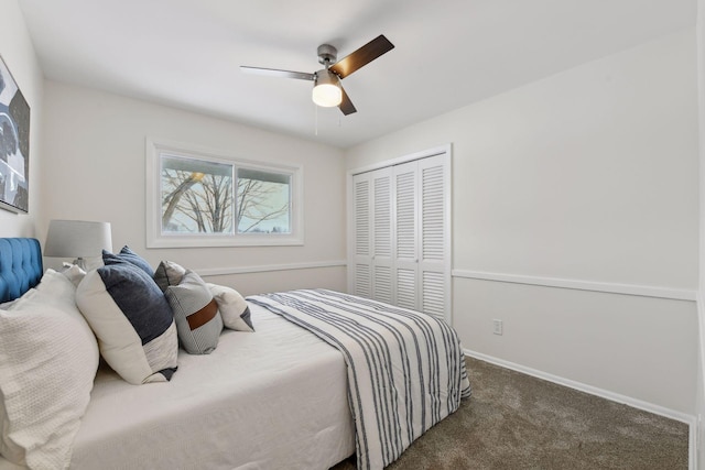 bedroom featuring ceiling fan, a closet, and dark carpet