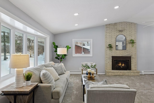 carpeted living room featuring baseboard heating, lofted ceiling, and a fireplace