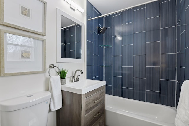 full bathroom featuring toilet, tiled shower / bath combo, and vanity