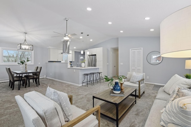 living room with light colored carpet, vaulted ceiling, and ceiling fan with notable chandelier