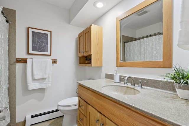 bathroom featuring toilet, vanity, a baseboard heating unit, and tile patterned flooring