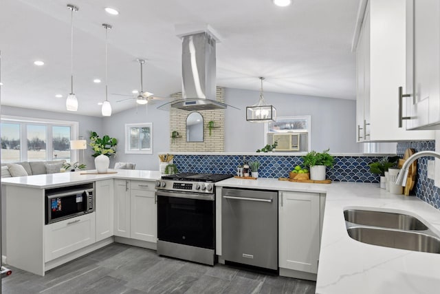 kitchen with stainless steel appliances, island range hood, white cabinetry, and hanging light fixtures