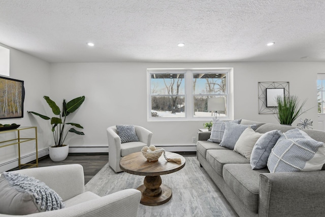 living room with a baseboard radiator, light wood-type flooring, and a textured ceiling