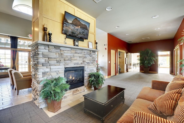 living room with a stone fireplace