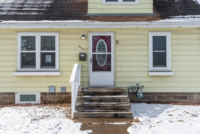 view of snow covered property entrance