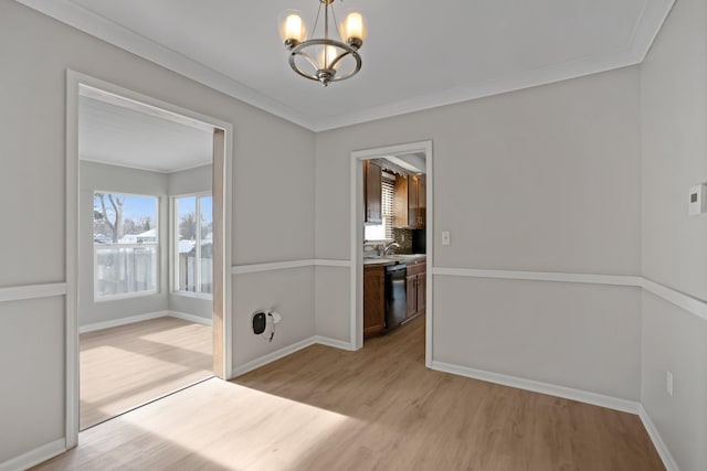 unfurnished dining area featuring light wood-type flooring, sink, a chandelier, and ornamental molding