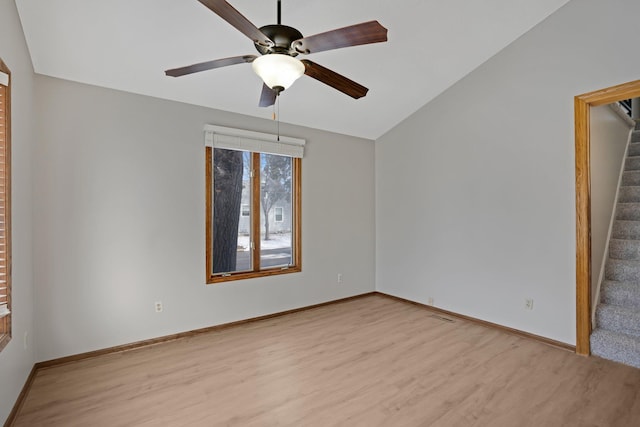 unfurnished room featuring ceiling fan, light hardwood / wood-style flooring, and vaulted ceiling