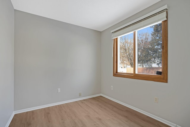 spare room with light hardwood / wood-style flooring