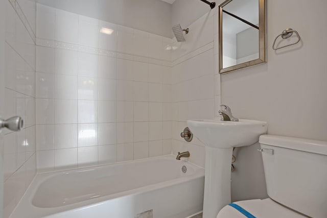 bathroom with toilet and tiled shower / bath combo