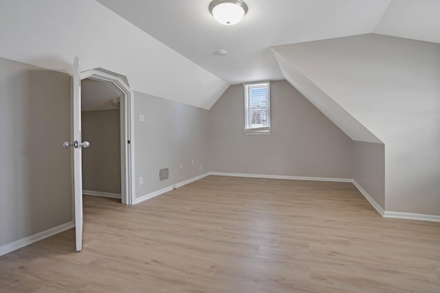 bonus room featuring light hardwood / wood-style flooring and lofted ceiling