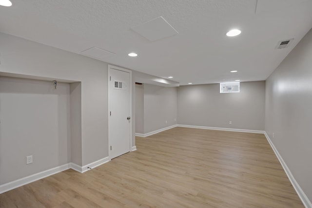 basement featuring light wood-type flooring