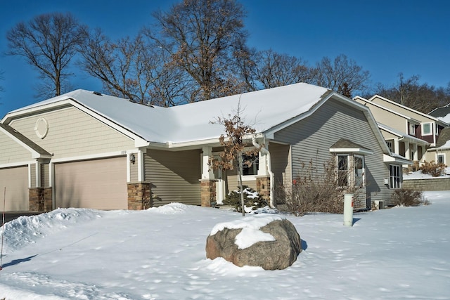 view of front of house with stone siding and an attached garage