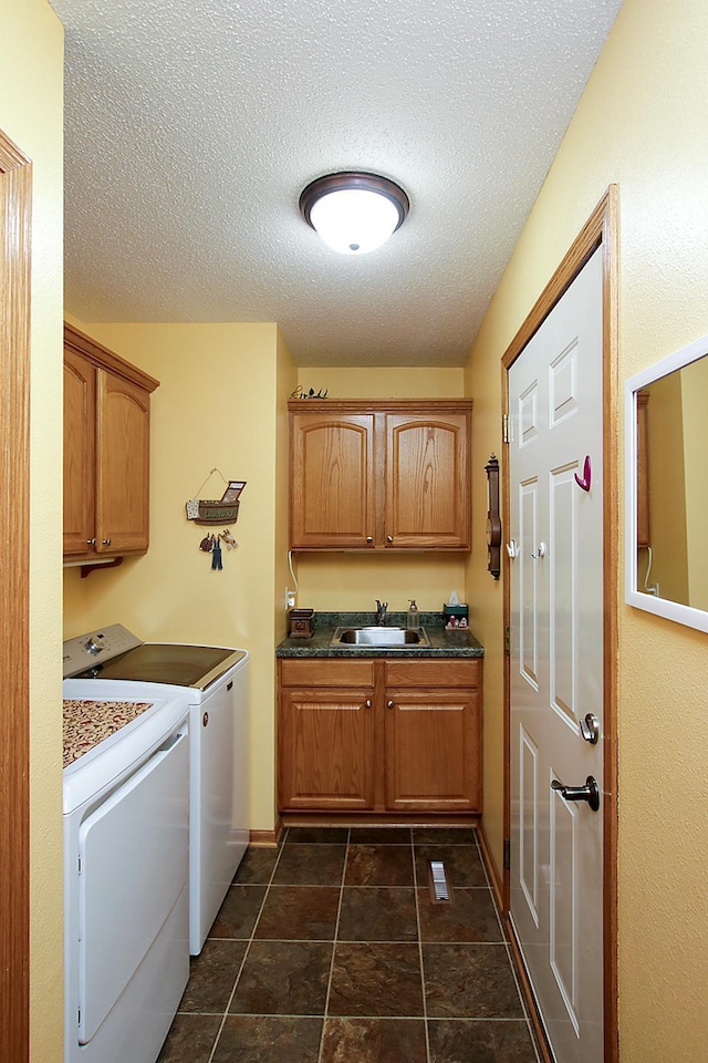 1406 Elsie Dr, Glencoe, MN 55336 - laundry area with washing machine and clothes dryer, cabinet space, a textured ceiling, and baseboards