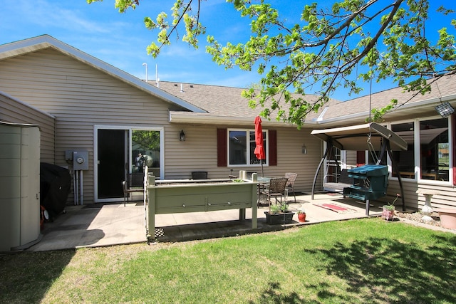 1406 Elsie Dr, Glencoe, MN 55336 - back of property with a patio area, a yard, and a shingled roof