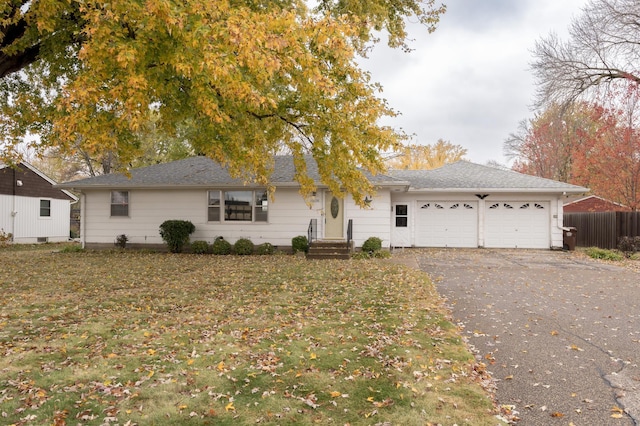 single story home with a garage and a front lawn