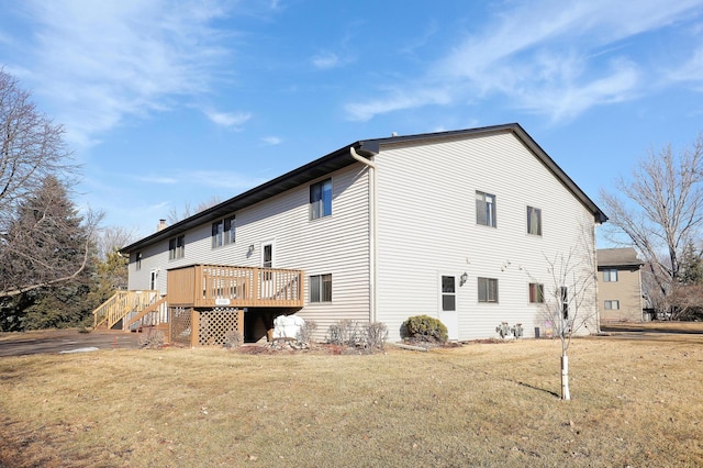 view of home's exterior featuring a yard, a wooden deck, and stairs