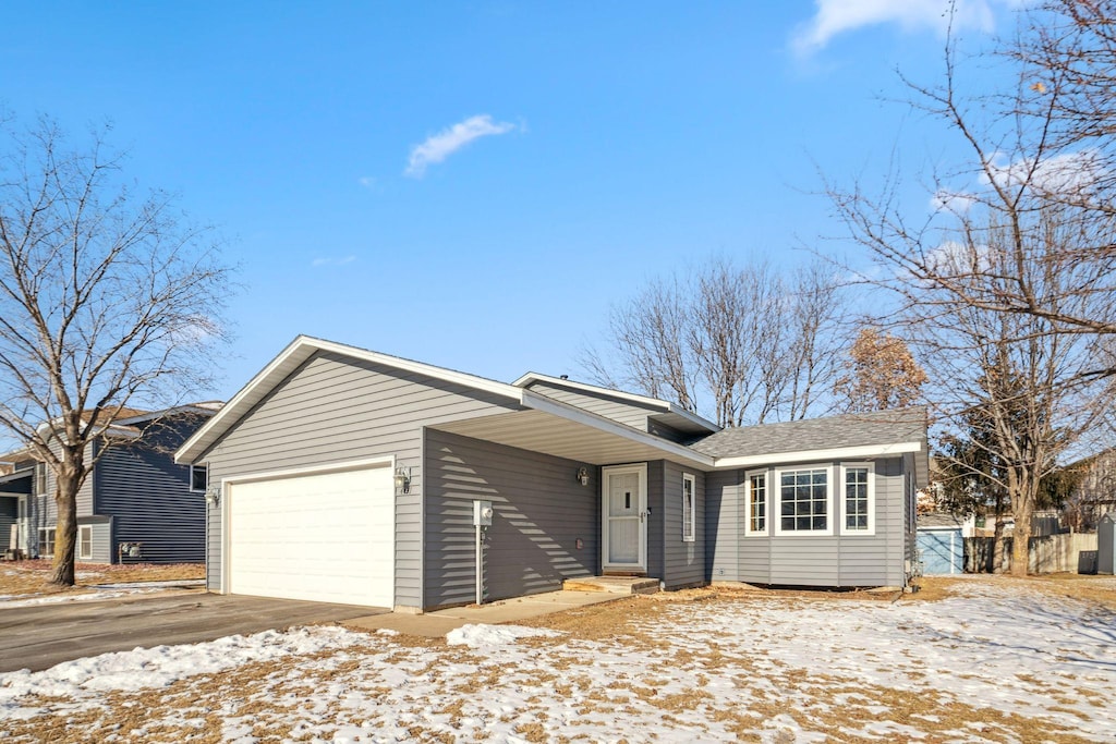 ranch-style home featuring a garage