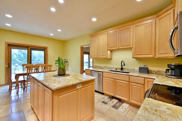 kitchen with stainless steel appliances, plenty of natural light, sink, and light brown cabinetry