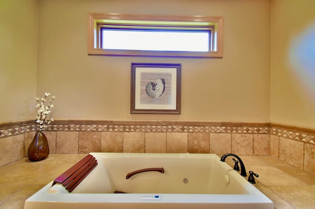 bathroom featuring plenty of natural light and a bathing tub