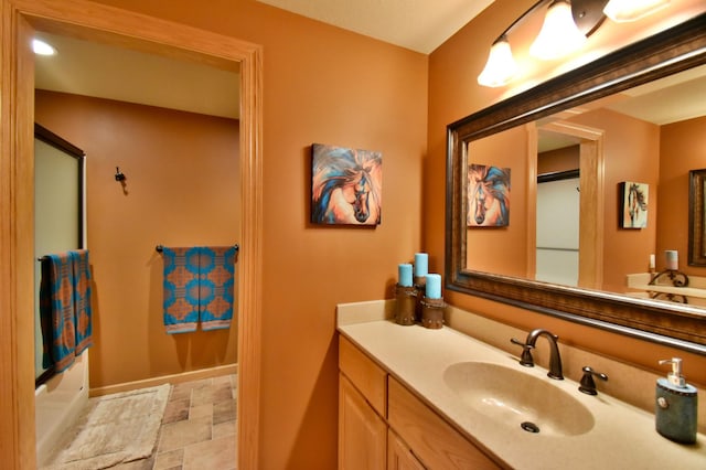 bathroom featuring vanity and shower / bath combination with glass door