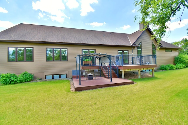 back of house featuring a wooden deck, a pergola, and a yard