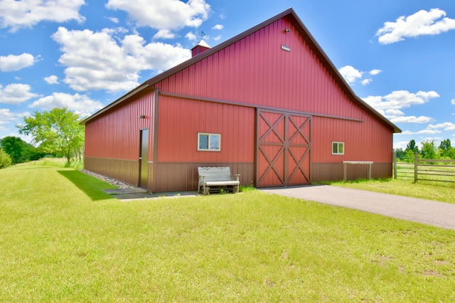 view of outbuilding featuring a yard