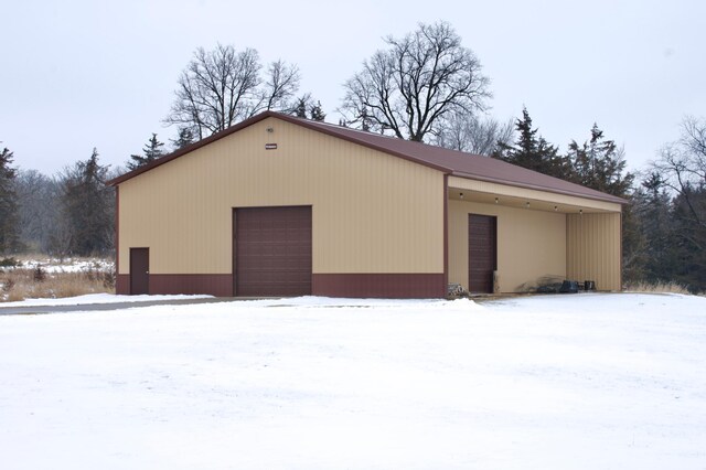 exterior space featuring a garage and an outdoor structure